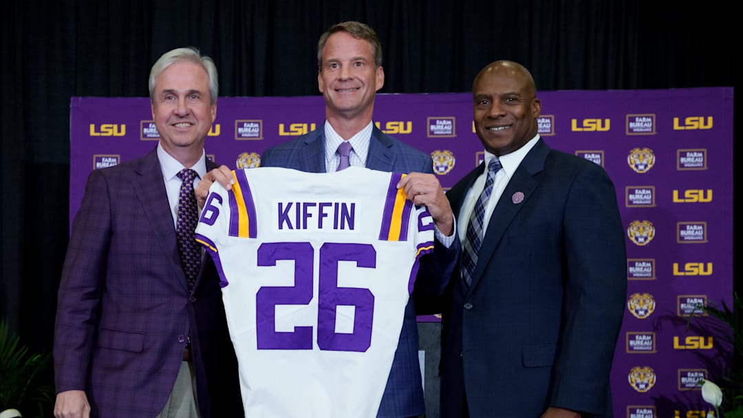 Dec 1, 2025; Baton Rouge, LA, USA; LSU president Wade Rousse, left, LSU new head coach Lane Kiffin and LSU athletic director Verge Ausberry stand together at South Stadium Club at Tiger Stadium. Mandatory Credit: Matthew Hinton-Imagn Images