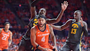 Feb 25, 2025; Champaign, Illinois, USA;  Illinois Fighting Illini guard Kylan Boswell (4) drives to the basket as Iowa Hawkeyes forward Seydou Traore (7) pressures during the first half at State Farm Center. Mandatory Credit: Ron Johnson-Imagn Images