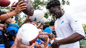 Detroit Lions cornerback Terrion Arnold (6) signs autographs for fans after practice at training camp at Meijer Performance Center in Allen Park on Thursday, August 21, 2025.