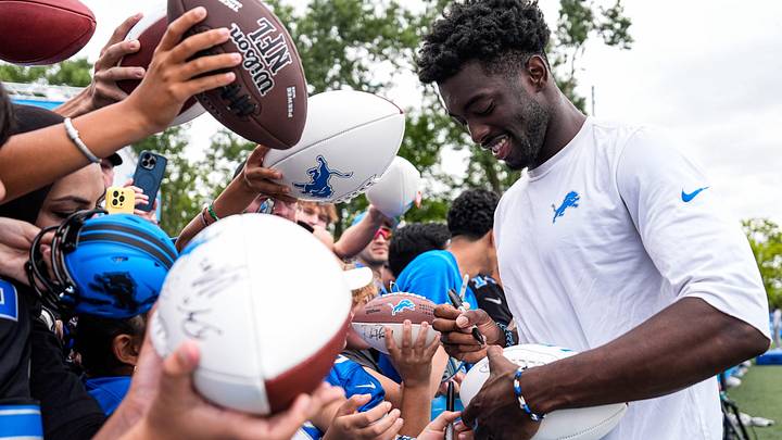 Detroit Lions cornerback Terrion Arnold (6) signs autographs for fans after practice at training camp at Meijer Performance Center in Allen Park on Thursday, August 21, 2025.