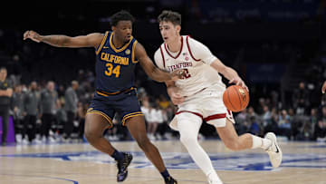 Mar 12, 2025; Charlotte, NC, USA; Stanford Cardinal forward Maxime Raynaud (42) drives to the basket against California Golden Bears forward Lee Dort (34) during the second half at Spectrum Center. Mandatory Credit: Jim Dedmon-Imagn Images
