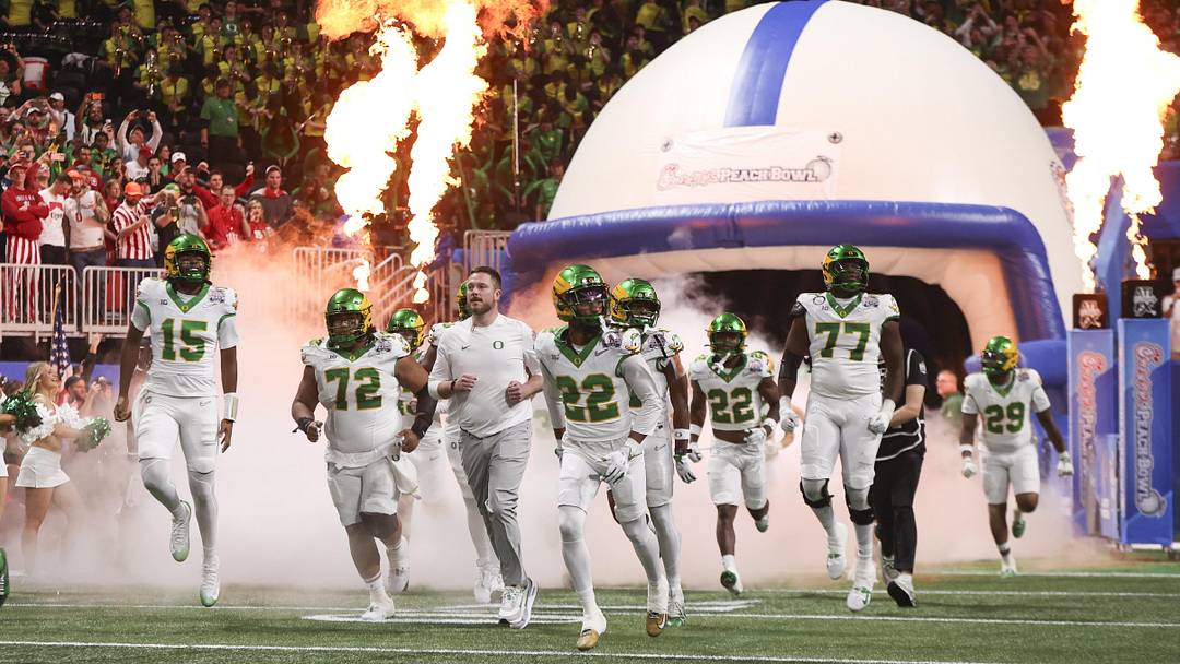 Jan 9, 2026; Atlanta, GA, USA; Oregon Ducks head coach Dan Lanning leads his team onto the field prior to the 2025 Peach Bowl and semifinal game of the College Football Playoff against the Indiana Hoosiers at Mercedes-Benz Stadium. Mandatory Credit: Brett Davis-Imagn Images