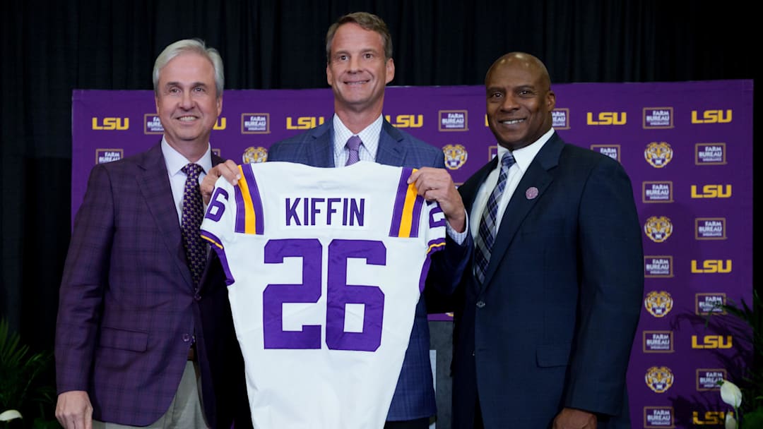 Dec 1, 2025; Baton Rouge, LA, USA; LSU president Wade Rousse, left, LSU new head coach Lane Kiffin and LSU athletic director Verge Ausberry stand together at South Stadium Club at Tiger Stadium. Mandatory Credit: Matthew Hinton-Imagn Images