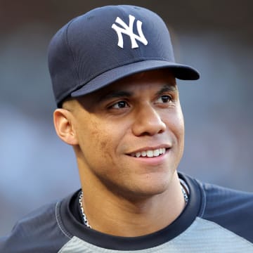 Jun 9, 2024; Bronx, New York, USA; New York Yankees right fielder Juan Soto (22) watches from the dugout during the third inning against the Los Angeles Dodgers at Yankee Stadium.