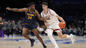 Mar 12, 2025; Charlotte, NC, USA; Stanford Cardinal forward Maxime Raynaud (42) drives to the basket against California Golden Bears forward Lee Dort (34) during the second half at Spectrum Center. Mandatory Credit: Jim Dedmon-Imagn Images
