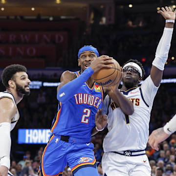 Jan 31, 2024; Oklahoma City, Oklahoma, USA; Oklahoma City Thunder guard Shai Gilgeous-Alexander (2) drives to the basket between Denver Nuggets guard Jamal Murray (27) and guard Reggie Jackson (7) during the second half at Paycom Center. Mandatory Credit: Alonzo Adams-Imagn Images