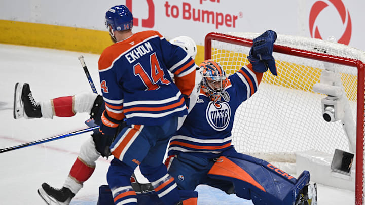 Jun 6, 2025; Edmonton, Alberta, CAN; Edmonton Oilers defenseman Mattias Ekholm (14) and goaltender Stuart Skinner (74) knock down Florida Panthers center Sam Bennett (9) during the first period in game two of the 2025 Stanley Cup Final at Rogers Place. 