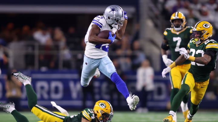 Jan 14, 2024; Arlington, Texas, USA; Dallas Cowboys wide receiver Michael Gallup (13) makes a catch over Green Bay Packers safety Jonathan Owens (34) during the second half of the  2024 NFC wild card game at AT&T Stadium. Mandatory Credit: Tim Heitman-USA TODAY Sports
