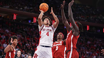 Nov 8, 2025; New York, New York, USA; St. John's basketball guard Oziyah Sellers (4) looks to drive past Alabama Crimson Tide forward Taylor Bol Bowen (7) in the second half at Madison Square Garden. 
