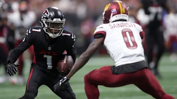 Atlanta Falcons wide receiver Darnell Mooney (1) runs against Washington Commanders cornerback Mike Sainristil (0) during the first half at Mercedes-Benz Stadium.