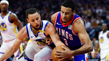 Feb 21, 2025; Sacramento, California, USA; Sacramento Kings forward Keegan Murray (13) and Golden State Warriors guard Stephen Curry (30) fight for a rebound during the first quarter at Golden 1 Center. Mandatory Credit: Sergio Estrada-Imagn Images