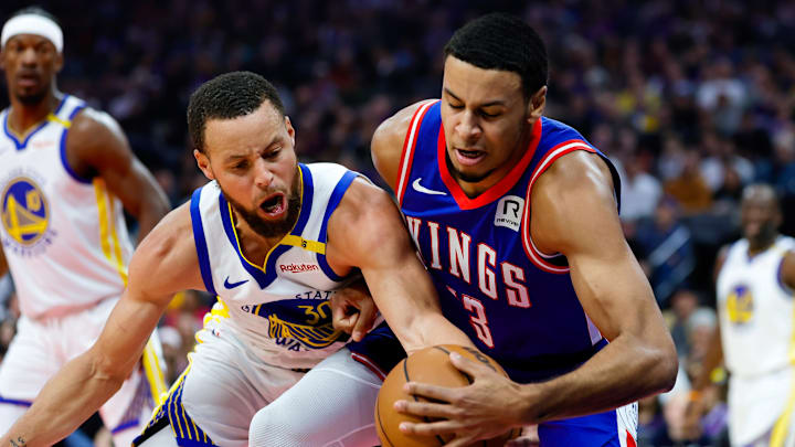 Feb 21, 2025; Sacramento, California, USA; Sacramento Kings forward Keegan Murray (13) and Golden State Warriors guard Stephen Curry (30) fight for a rebound during the first quarter at Golden 1 Center. Mandatory Credit: Sergio Estrada-Imagn Images