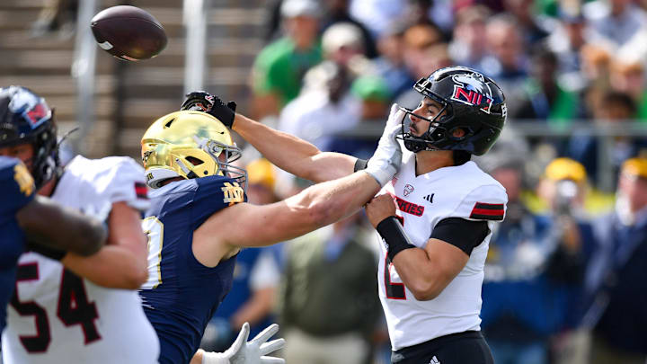 Sep 7, 2024; South Bend, Indiana, USA; Northern Illinois Huskies quarterback Ethan Hampton (2) throws a pass for a touchdown as he is pressured by Notre Dame Fighting Irish defensive lineman Rylie Mills (99) in the first quarter at Notre Dame Stadium. Mandatory Credit: Matt Cashore-Imagn Images