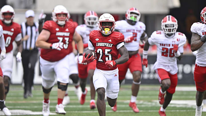 Aug 31, 2024; Louisville, Kentucky, USA;  Louisville Cardinals running back Isaac Brown (25) runs the ball against the Austin Peay Governors during the second half at L&N Federal Credit Union Stadium. Louisville defeated Austin Peay 62-0. Mandatory Credit: Jamie Rhodes-Imagn Images