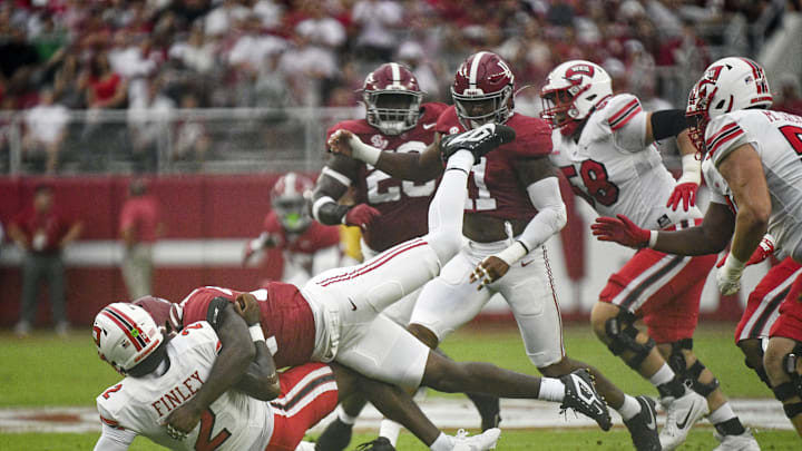 Aug 31, 2024; Tuscaloosa, Alabama, USA;  Western Kentucky Hilltoppers quarterback TJ Finely is brought down by Alabama Crimson Tide defensive lineman LT Overton (22) during the first half at Bryant-Denny Stadium. Mandatory Credit: Gary Cosby Jr.-Imagn Images