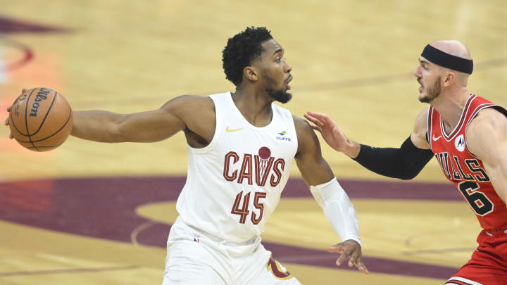 Jan 15, 2024; Cleveland, Ohio, USA; Chicago Bulls guard Alex Caruso (6) defends Cleveland Cavaliers guard Donovan Mitchell (45) in the first quarter at Rocket Mortgage FieldHouse. Mandatory Credit: David Richard-USA TODAY Sports