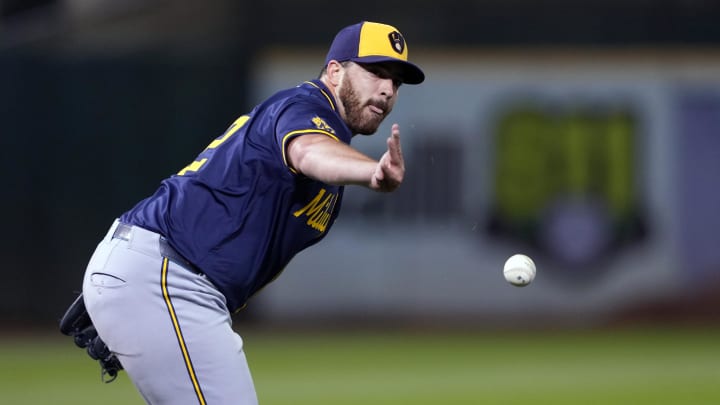 Aug 23, 2024; Oakland, California, USA; Milwaukee Brewers starting pitcher Aaron Civale (32) tosses the ball to first base to record an out against the Oakland Athletics during the fourth inning at Oakland-Alameda County Coliseum. Mandatory Credit: Darren Yamashita-USA TODAY Sports