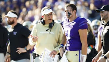 Sep 21, 2024; Seattle, Washington, USA; Washington Huskies head coach Jedd Fisch talks with quarterback Will Rogers (7) during the second quarter against the Northwestern Wildcats at Alaska Airlines Field at Husky Stadium. Mandatory Credit: Joe Nicholson-Imagn Images