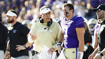 Sep 21, 2024; Seattle, Washington, USA; Washington Huskies head coach Jedd Fisch talks with quarterback Will Rogers (7) during the second quarter against the Northwestern Wildcats at Alaska Airlines Field at Husky Stadium. Mandatory Credit: Joe Nicholson-Imagn Images