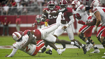 Aug 31, 2024; Tuscaloosa, Alabama, USA;  Western Kentucky Hilltoppers quarterback TJ Finely is brought down by Alabama Crimson Tide defensive lineman LT Overton (22) during the first half at Bryant-Denny Stadium. Mandatory Credit: Gary Cosby Jr.-Imagn Images