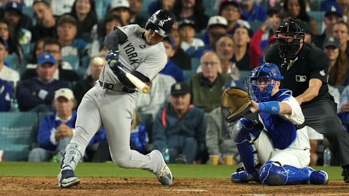 Oct 26, 2024; Los Angeles, California, USA; New York Yankees outfielder Juan Soto (22) hits a single against the Los Angeles Dodgers in the ninth inning for game two of the 2024 MLB World Series at Dodger Stadium. Mandatory Credit: Kirby Lee-Imagn Images