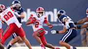 Sep 14, 2024; Logan, Utah, USA;  Utah Utes running back Micah Bernard (2) runs with the ball against the Utah State Aggies at Merlin Olsen Field at Maverik Stadium. 