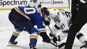 Nov 7, 2024; St. Louis, Missouri, USA; St. Louis Blues center Oskar Sundqvist (70) takes a face-off against Utah Hockey Club center Barrett Hayton (27) during the third period at Enterprise Center. Mandatory Credit: Jeff Le-Imagn Images