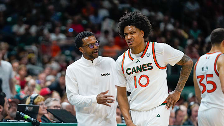 Mar 7, 2026; Coral Gables, Florida, USA; Miami Hurricanes head coach Jai Lucas talks to guard Tru Washington (10) after a foul against the Louisville Cardinals during the second half at Watsco Center. Mandatory Credit: Jeff Romance-Imagn Images