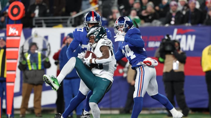 Jan 7, 2024; East Rutherford, New Jersey, USA; Philadelphia Eagles wide receiver Quez Watkins (16) catches a touchdown pass in front of New York Giants safety Dane Belton (24) and cornerback Tre Hawkins III (37) during the second half at MetLife Stadium.  