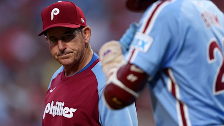  Philadelphia Phillies manager Rob Thomson (R) checks third base Alec Bohm (28) after an apparent injury during the first inning against the Atlanta Braves at Citizens Bank Park.