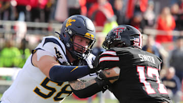 Nov 30, 2024; Lubbock, Texas, USA;  West Virginia Mountaineers offensive tackle Nick Malone (58) blocks Texas Tech Red Raiders defensive linebacker Isaac Smith (17) in the second half at Jones AT&T Stadium and Cody Campbell Field. Mandatory Credit: Michael C. Johnson-Imagn Images