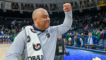 Dec 30, 2023; South Bend, Indiana, USA; Notre Dame Fighting Irish head coach Micah Shrewsberry celebrates as he leaves the court following the 76-54 win over the Virginia Cavaliers at the Purcell Pavilion. Mandatory Credit: Matt Cashore-Imagn Images
