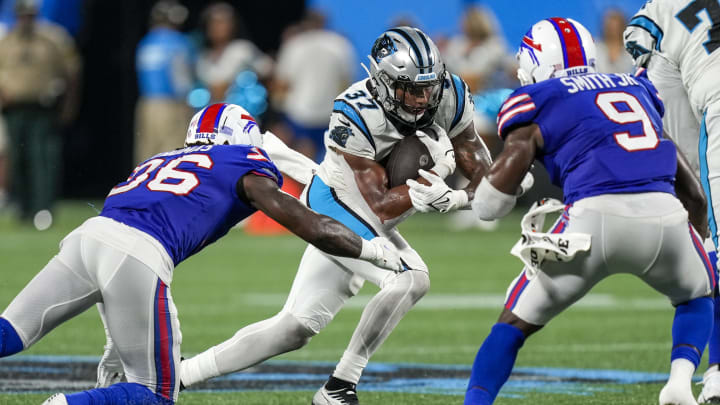 Aug 26, 2022; Charlotte, North Carolina, USA; Buffalo Bills defensive end Daniel Joseph (96) attempt to tackle Carolina Panthers running back John Lovett (37) during the second half at Bank of America Stadium. 