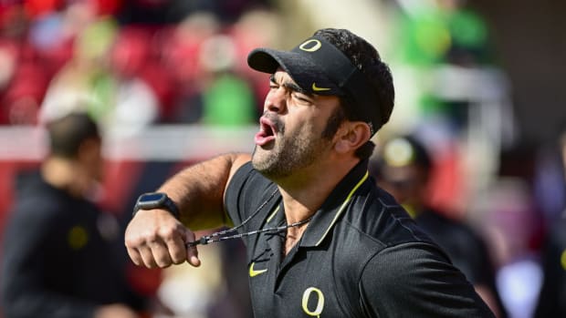 Oregon Ducks head football conditioning coach Wilson Love calls drills before a game against the Utah Utes at Rice-Eccles 
