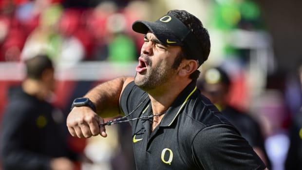 Oregon Ducks head football conditioning coach Wilson Love calls drills before a game against the Utah Utes at Rice-Eccles Sta