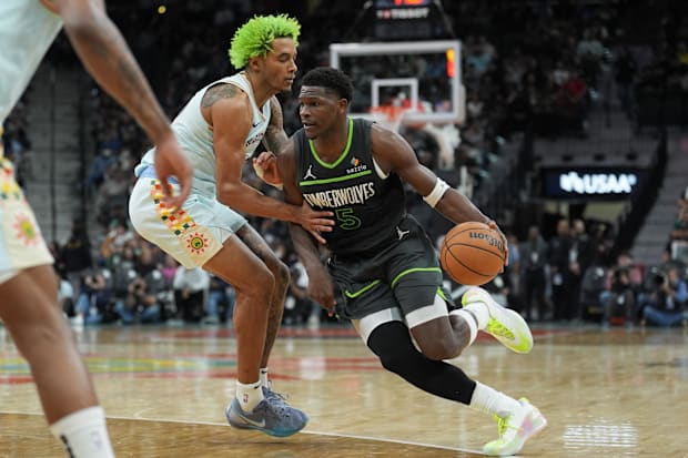 Minnesota Timberwolves defender Anthony Edwards (5) dribbles against San Antonio Spurs forward Jeremy Sochan (10).