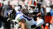 Oct 27, 2024; Cleveland, Ohio, USA; Cleveland Browns defensive end Ogbo Okoronkwo (54) tackles Baltimore Ravens tight end Mark Andrews (89) during the first half at Huntington Bank Field. Mandatory Credit: Ken Blaze-Imagn Images