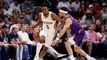 Phoenix Suns guard Devin Booker pokes the ball away from new Orleans Pelicans forward Herbert Jones.