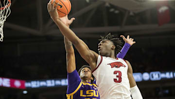 Feb 12, 2025; Fayetteville, Arkansas, USA;  Arkansas Razorbacks forward Adou Thiero (3) goes for a layup past LSU Tigers forward Derek Fountain (20) during the second half at Bud Walton Arena. Arkansas won 70-58. Mandatory Credit: Brett Rojo-Imagn Images