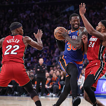 Jan 27, 2024; New York, New York, USA; New York Knicks forward Julius Randle (30) drives to the basket as Miami Heat forward Jimmy Butler (22) and forward Haywood Highsmith (24) defend during the second half at Madison Square Garden. Mandatory Credit: Vincent Carchietta-Imagn Images