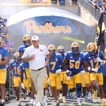Aug 30, 2025; Pittsburgh, Pennsylvania, USA; Pittsburgh Panthers head coach Pat Narduzzi (middle) leads the team onto the field to play the Duquesne Dukes at Acrisure Stadium. Mandatory Credit: Charles LeClaire-Imagn Images
