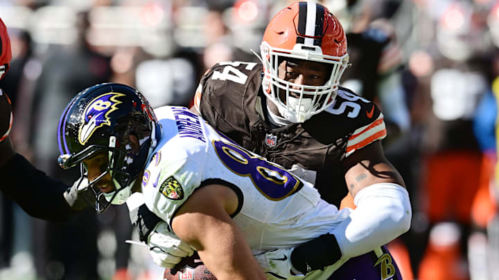Oct 27, 2024; Cleveland, Ohio, USA; Cleveland Browns defensive end Ogbo Okoronkwo (54) tackles Baltimore Ravens tight end Mark Andrews (89) during the first half at Huntington Bank Field. Mandatory Credit: Ken Blaze-Imagn Images