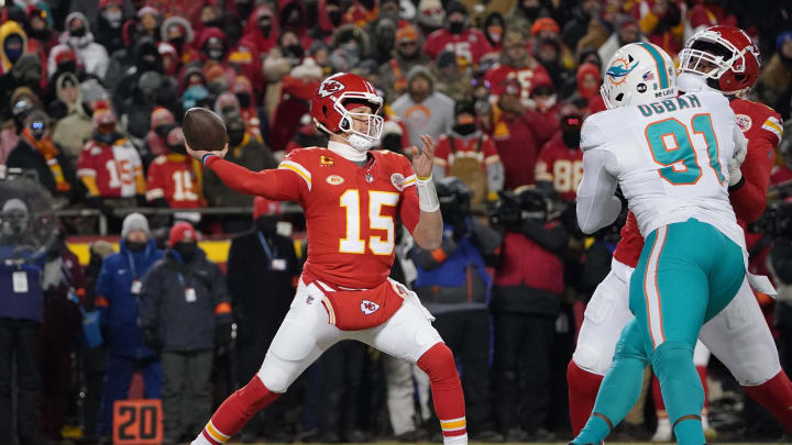 Jan 13, 2024; Kansas City, Missouri, USA; Kansas City Chiefs quarterback Patrick Mahomes (15) throws under pressure from Miami Dolphins defensive end Emmanuel Ogbah (91) during the first half of the 2024 AFC wild card game at GEHA Field at Arrowhead Stadium.