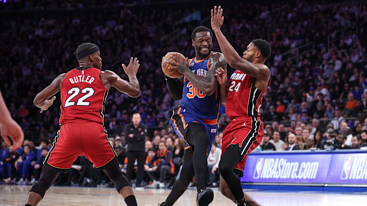 Jan 27, 2024; New York, New York, USA; New York Knicks forward Julius Randle (30) drives to the basket as Miami Heat forward Jimmy Butler (22) and forward Haywood Highsmith (24) defend during the second half at Madison Square Garden. Mandatory Credit: Vincent Carchietta-Imagn Images