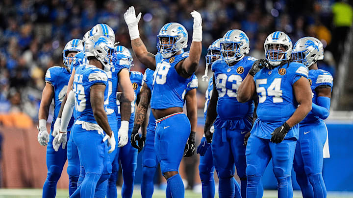 Detroit Lions defensive end Za'Darius Smith (99) cheers on during a huddle before a play against Chicago Bears during the first half at Ford Field in Detroit on Thursday, Nov. 28, 2024.
