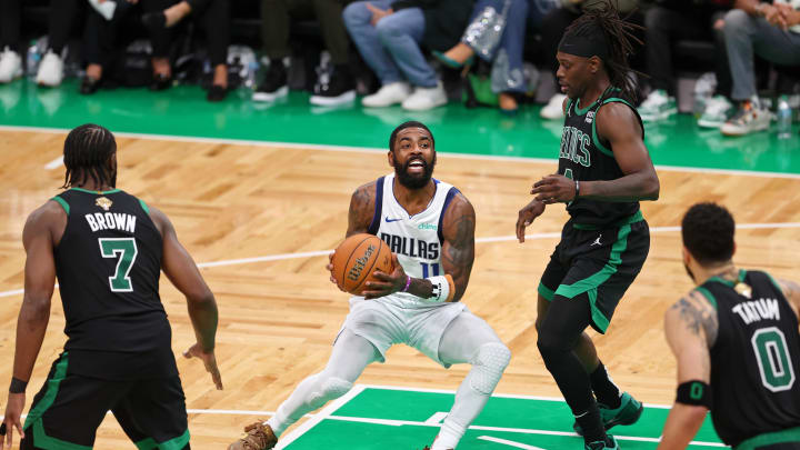 Jun 9, 2024; Boston, Massachusetts, USA; Dallas Mavericks guard Kyrie Irving (11) controls the ball against Boston Celtics guard Jrue Holiday (4) 