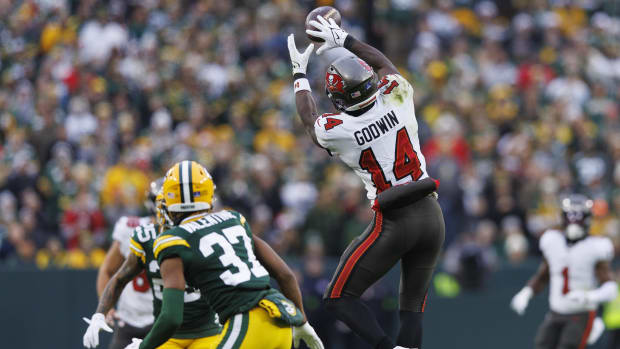 Tampa Bay Buccaneers wide receiver Chris Godwin (14) leaps to catch a pass against the Green Bay Packers 