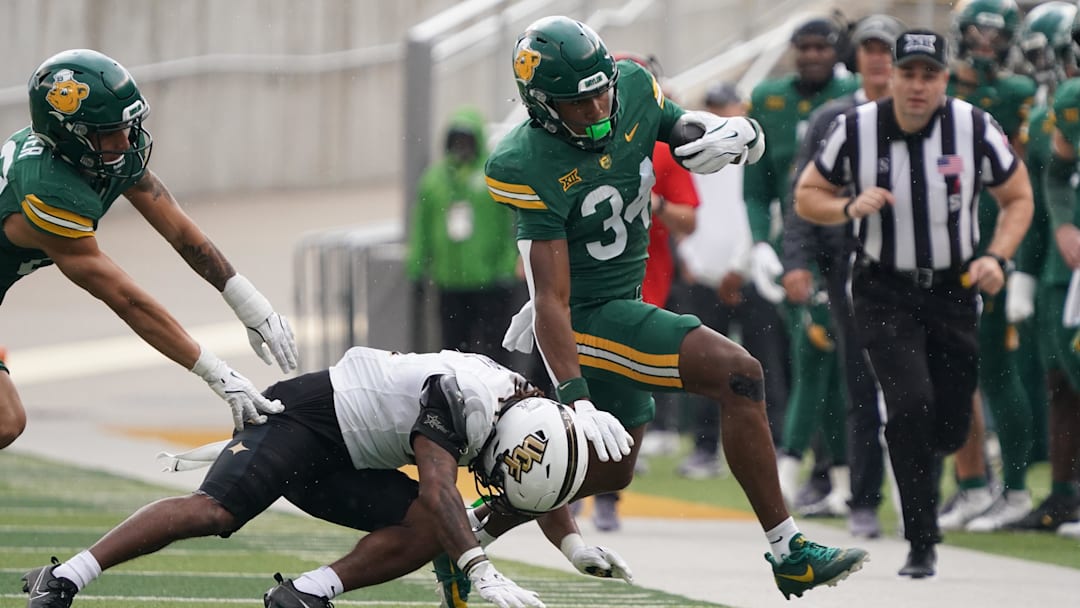 Nov 1, 2025; Waco, Texas, USA; Baylor Bears wide receiver Josh Cameron (34) is forced out of bounds by UCF Knights defensive back Braeden Marshall (4) during the first half at McLane Stadium. Mandatory Credit: Raymond Carlin III-Imagn Images