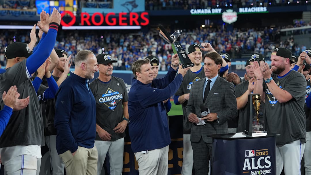 Ed Rogers, chairman of the Toronto Blue Jays, holds up the William Harridge trophy after the Blue Jays defeated the Seattle Mariners in Game 7 of the 2025 American League Championship Series in October. Photo by Nick Turchiaro-Imagn Images.