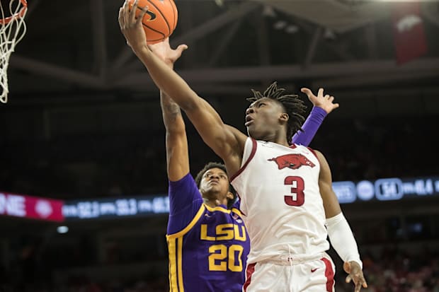 Arkansas Razorbacks forward Adou Thiero goes for a lay-up past LSU Tigers forward Derek Fountain.